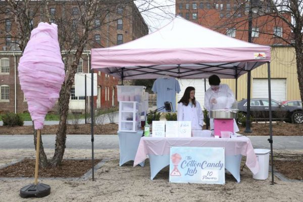 In this Saturday, March 14, 2020, photo, Lynley Golden, left, and Jason Rony at the Cotton Candy Lab booth near The Depot Grille in Lynchburg, Va. While making the cotton candy — of which he offers 10 flavors, with more in the works — he wears a lab coat and goggles and explains to children the science behind how the treat is made. (Taylor Irby/The News & Advance via AP) Photo: Taylor Irby, AP / The News & Advance