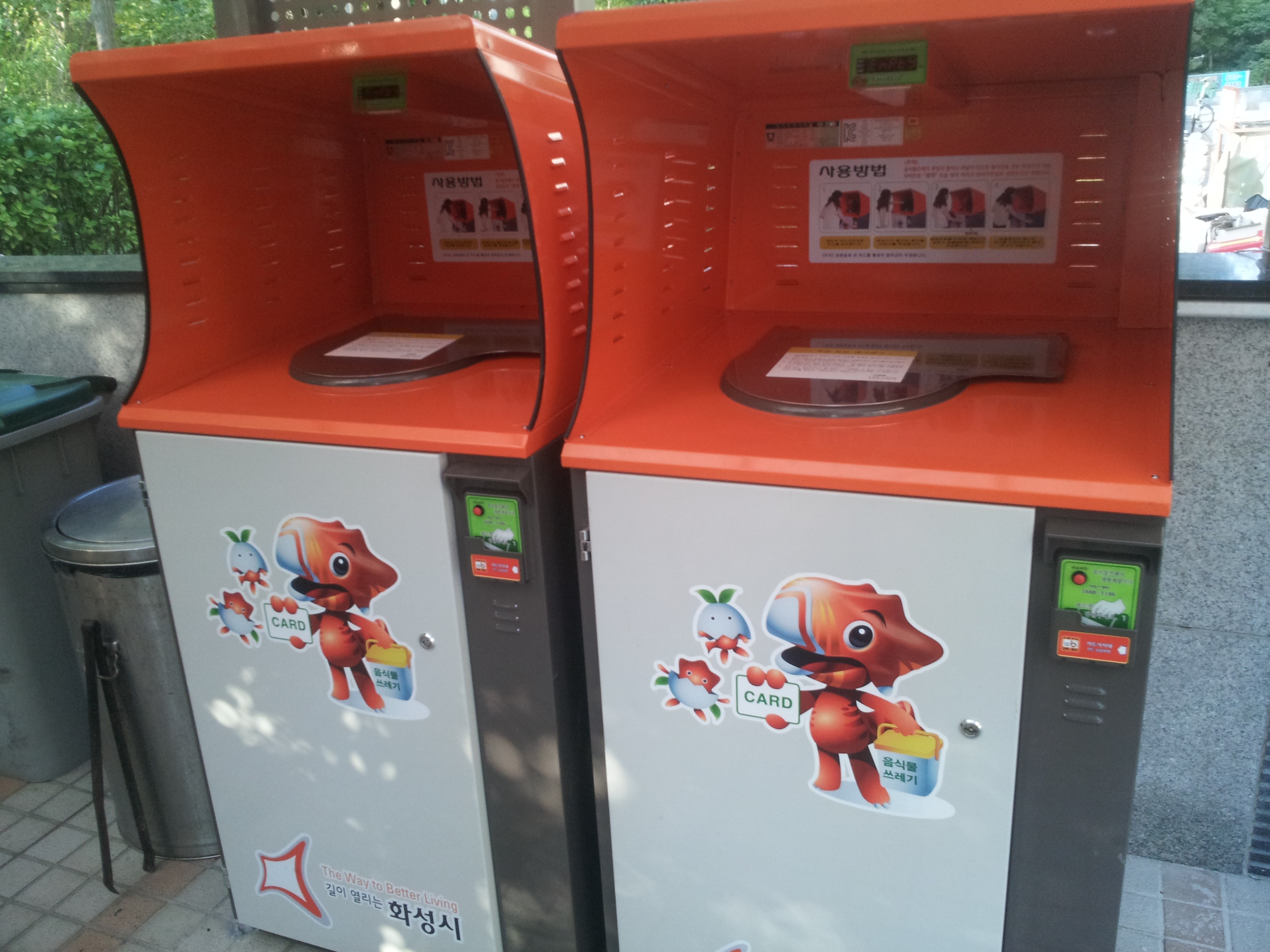 Two bins marked with cartoons and colorful graphics showing what they collect