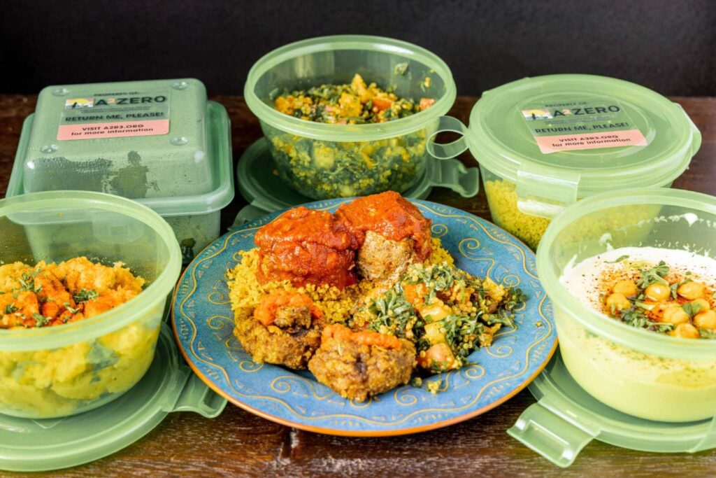 Reusable containers filled with takeout food from El Harissa Market Cafe in Ann Arbor. For their study, University of Michigan researchers studied the pilot program for returnable takeout containers launched by the nonprofit organization Live Zero Waste in Ann Arbor. The program, Ann Arbor Reduce, Reuse, Return (A2R3), is now in its second pilot phase and was implemented in partnership with the city of Ann Arbor’s A2ZERO carbon neutrality plan. Photo credit: Live Zero Waste